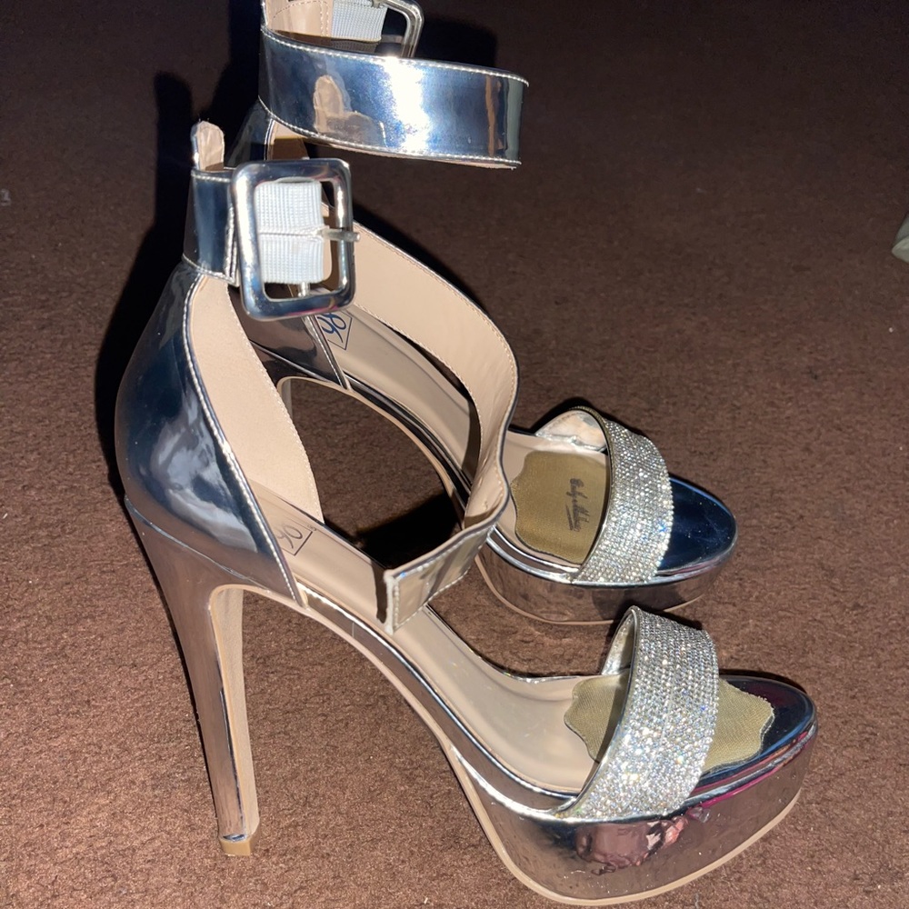 US Women’s size 8.5, shiny reflective, silver 5 inch heels with rhinestones.